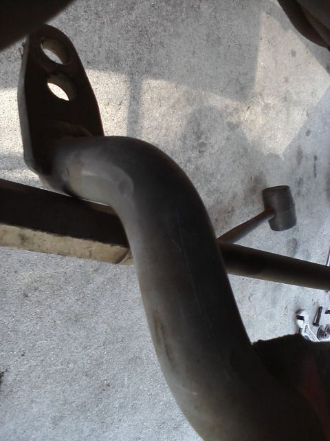 1995 Ford Taurus - A metal tow hitch assembly is shown, with a rubber mallet and tools visible in the background.