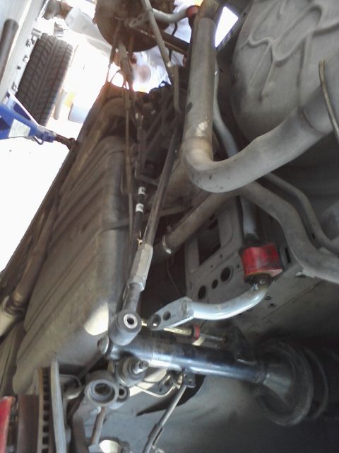 1995 Ford Taurus - Undercarriage view showing suspension components, fuel tank, and exhaust system.