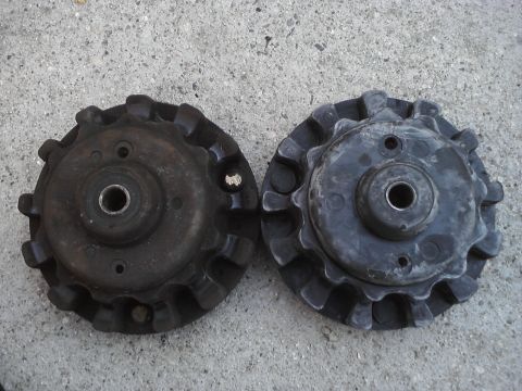 1995 Ford Taurus - Two automotive parts with toothed edges are shown side-by-side on a concrete surface.