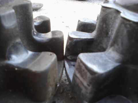 1995 Ford Taurus - A close-up view of two dark tire treads, showing their aggressive pattern.