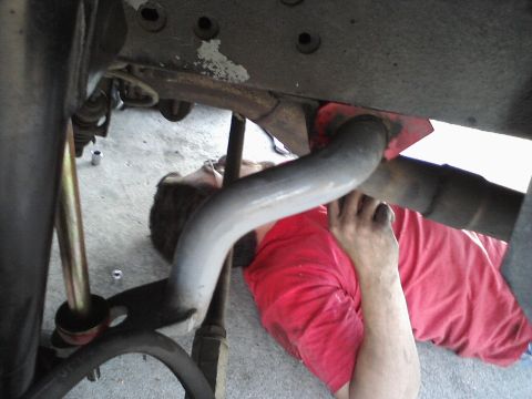 1995 Ford Taurus - Mechanic working on the exhaust system of a vehicle.