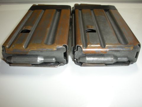 1996 Ford Bronco - Two rifle magazines with visible wear and rust are shown on a white surface.