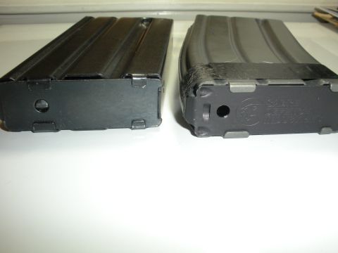 1996 Ford Bronco - Two rifle magazines are shown, one with tape around its base. Text is visible on the base of the right magazine.