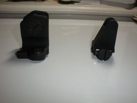 1996 Ford Bronco - Two adjustable iron sights are shown on a white surface, likely for a firearm.