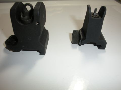1996 Ford Bronco - Two rifle sights are shown on a white surface.