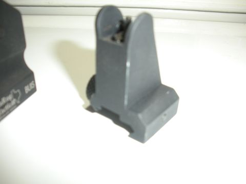 1996 Ford Bronco - A close-up view of a gun sight part is shown, with some text visible on an adjacent object.