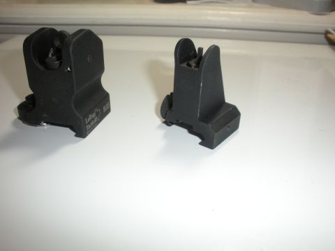 1996 Ford Bronco - Two black iron sights are displayed on a white surface, with text visible on one of them.