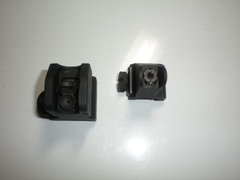1996 Ford Bronco - Two black flip-up iron sights are shown, likely for a firearm, not a vehicle.