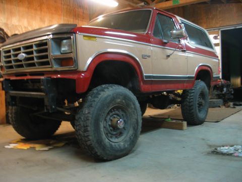 1984 Ford Bronco - This lifted Ford Bronco has a two-tone red and tan paint scheme and appears to be from the early 1980s.