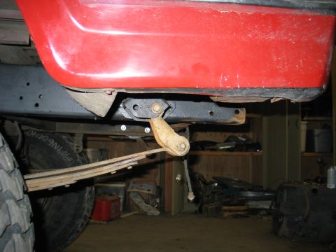 1984 Ford Bronco - Close-up of the suspension and lower body panel of a 1984 Ford Bronco, highlighting its construction.
