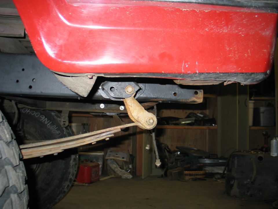 1984 Ford Bronco side view showing leaf spring suspension and red body panel