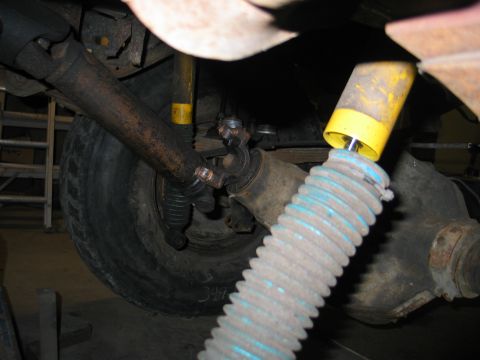 1984 Ford Bronco - Close-up of vehicle undercarriage with driveshaft and suspension parts visible.