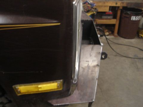 1989 Ford Bronco - Custom metal fender flare is being fabricated for a dark brown vehicle, obscuring most of the body details.