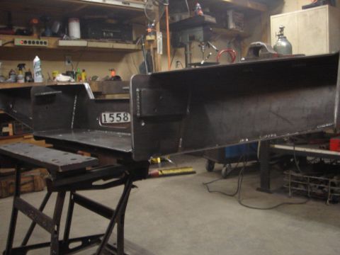 1989 Ford Bronco - A metal frame, possibly a vehicle part, is displayed in a workshop setting.