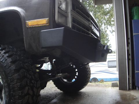 1989 Ford Bronco - Close-up view of the front of a truck, showing its heavy-duty bumper and off-road tire.