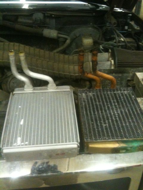 1993 Ford Bronco - Comparison of a new and old heater core in a vehicle's engine compartment.