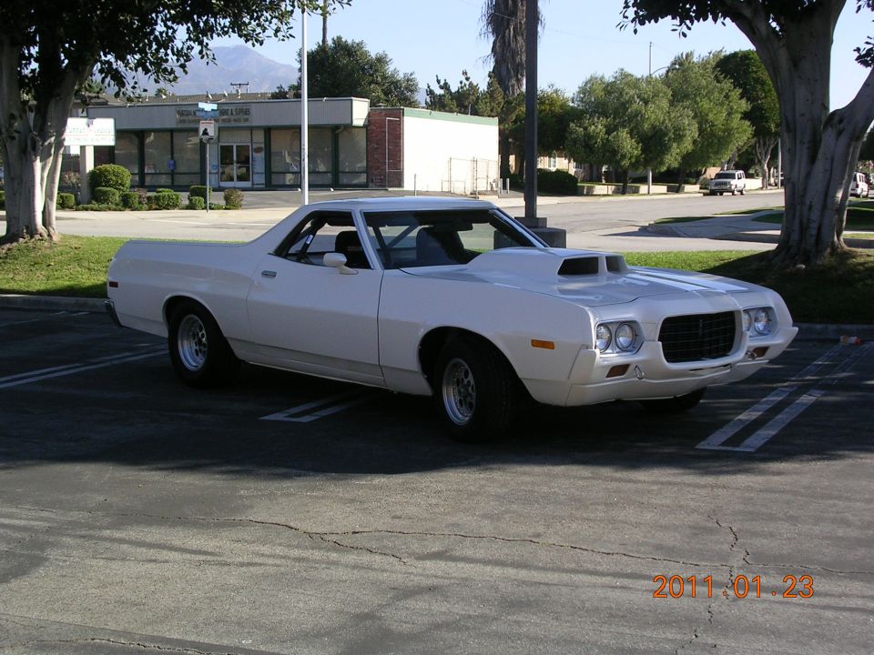 White 1972 Ford Ranchero parked in a lot, showing its front end and hood scoop