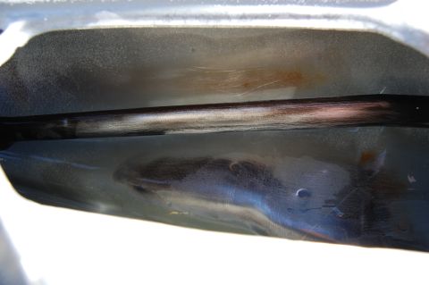 1994 Ford Bronco - Close-up of the interior of a car door frame, showing a metal bar.