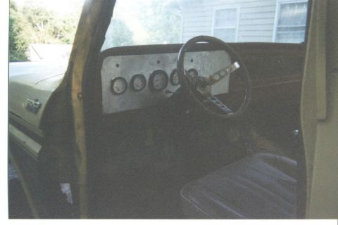 1978 Ford Bronco - Custom dashboard with gauges and steering wheel inside a vehicle.
