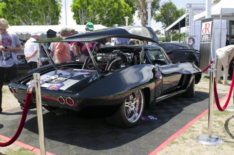2006 Cadillac STS - A heavily modified vintage Corvette is displayed with its engine exposed, custom modifications.