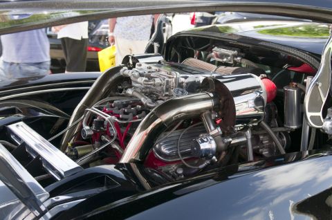2006 Cadillac STS - Close-up of a modified car engine with polished metal components and bright red accents.