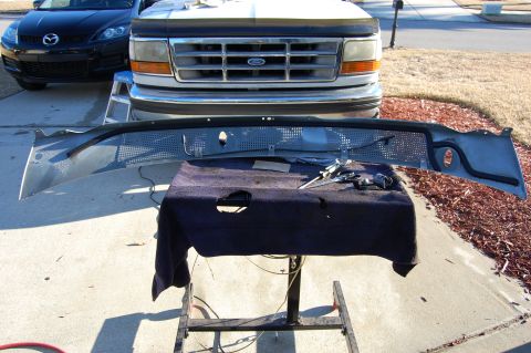 1994 Ford Bronco - Removed grille and windshield trim from a 1992 Ford Bronco, with a Mazda CX-7 visible in the background.