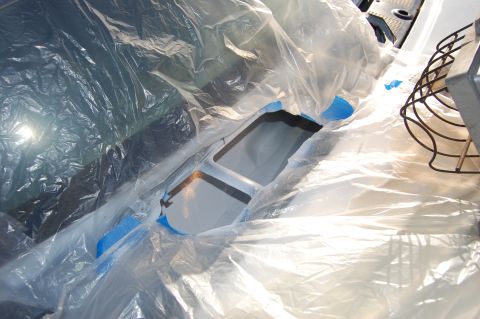 1994 Ford Bronco - Plastic sheeting covers the interior of a vehicle, likely for protection during work. Supermotors.net logo is present.
