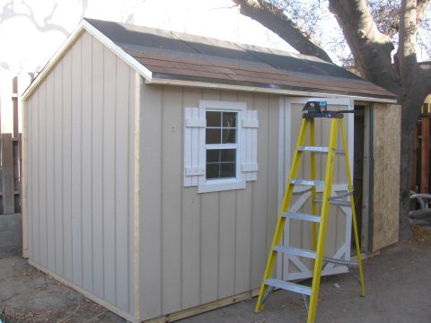1968 Ford Mustang - A tan shed with a window and a ladder is shown outdoors.