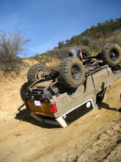 1989 Ford Bronco - Off-road Bronco rolled onto its side during an excursion on a steep dirt incline.