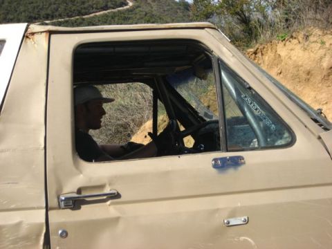 1989 Ford Bronco - Driver of a tan 1989 Ford Bronco on an off-road trail.