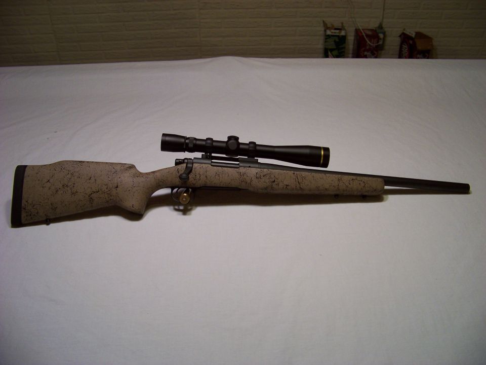 Rifle with scope, speckled camouflage stock