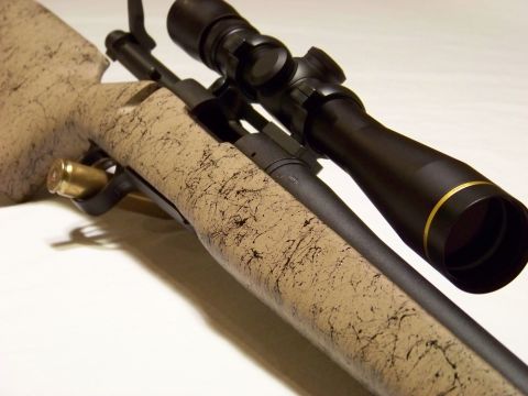 1995 Mercury Grand Marquis - Bolt-action rifle with scope and cartridge.