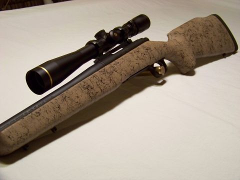 1995 Mercury Grand Marquis - A rifle with a scope is shown on a white surface.