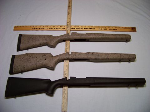 1995 Mercury Grand Marquis - Three rifle stocks are displayed with measuring rulers, showing different finishes and designs.