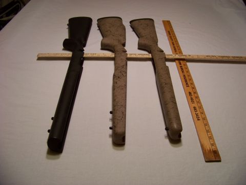 1995 Mercury Grand Marquis - Three rifle stocks are laid out with a wooden ruler for size comparison, suggesting a focus on firearm components.
