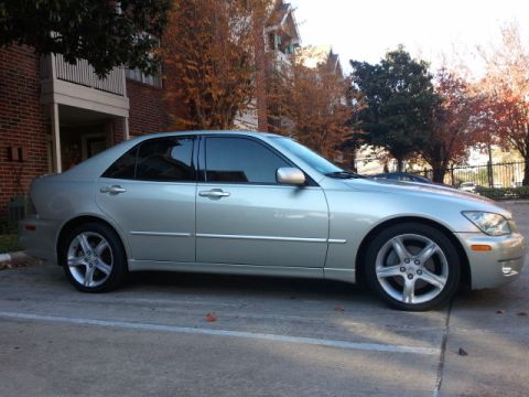 2008 Subaru Legacy - A silver sedan is parked in a lot with a brick building and trees in the background.