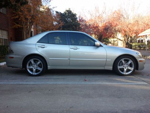 2008 Subaru Legacy - A silver sedan is parked outdoors with fall foliage and a building visible behind it.