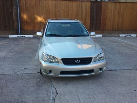 2008 Subaru Legacy - A silver Lexus IS300 is parked in a lot, facing the camera, with a wooden fence in the background.