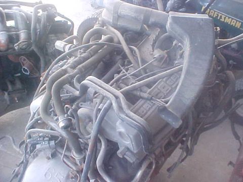 1996 Ford Bronco - Close-up view of a complex engine assembly with numerous hoses and wiring.