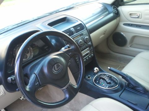 2008 Subaru Legacy - The interior of a Lexus IS features a leather-wrapped steering wheel and a beige interior.