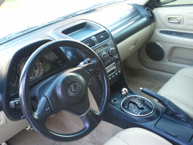 Interior shot of a Lexus IS, showing the steering wheel, dashboard, and center console with automatic shifter