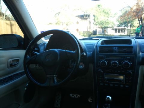 2008 Subaru Legacy - Interior view of a car, showing the dashboard, steering wheel, and door panel, with a visible website logo at the bottom.