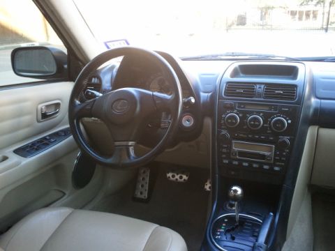 2008 Subaru Legacy - Interior of a Lexus IS300, likely from the mid-2000s, with a prominent Lexus logo on the steering wheel.