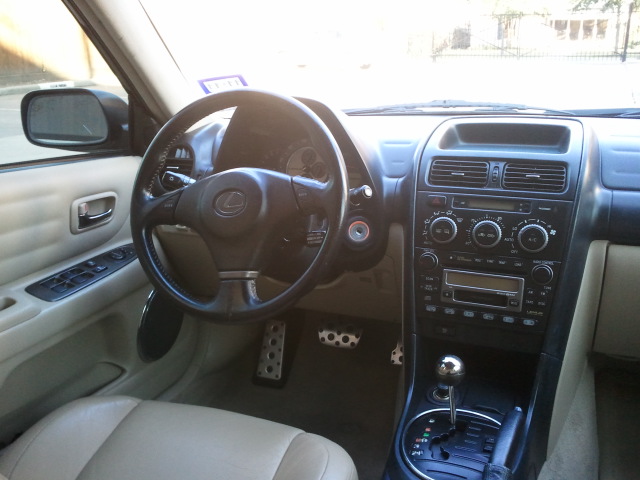 Interior view of a Lexus IS300 showing the steering wheel, dashboard, and center console