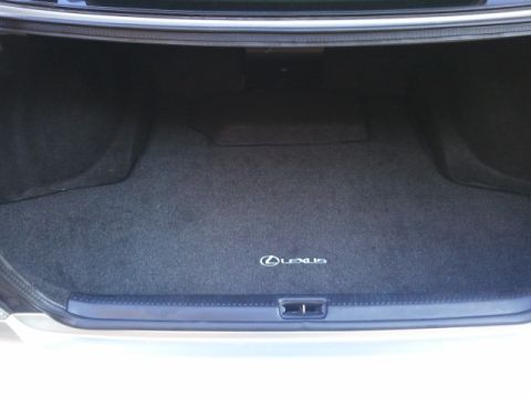 2008 Subaru Legacy - The trunk of a car shows a carpeted floor with a Lexus emblem. The trunk lid is open.