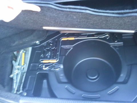 2008 Subaru Legacy - The spare tire well and jack are visible in the trunk of a vehicle.