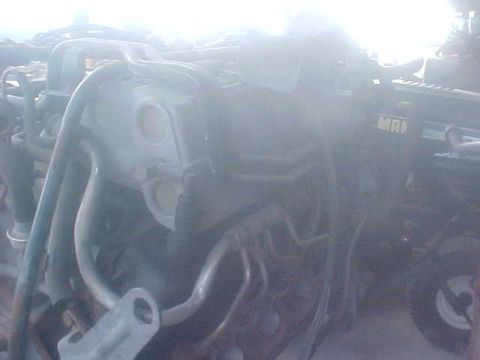 1996 Ford Bronco - Close-up view of engine components, including hoses and metal brackets, with partial text visible.
