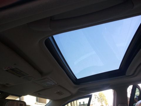 2008 Subaru Legacy - Sunroof open on a clear day, showing the interior of the vehicle.