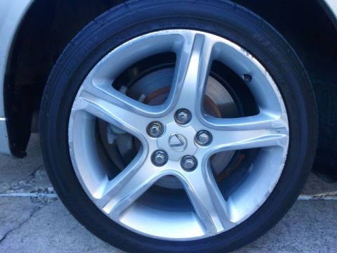2008 Subaru Legacy - Close-up of a vehicle's wheel the Lexus emblem and a five-spoke design.
