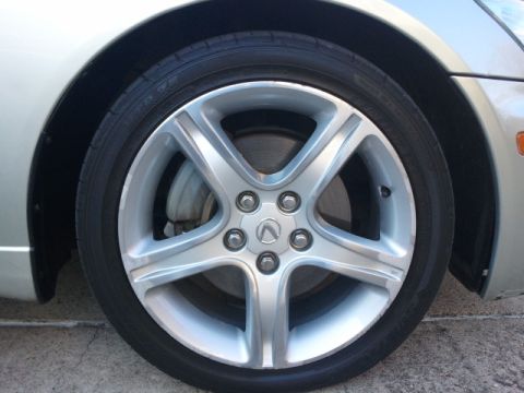 2008 Subaru Legacy - Close-up of a silver alloy wheel with a Lexus logo on a car tire.